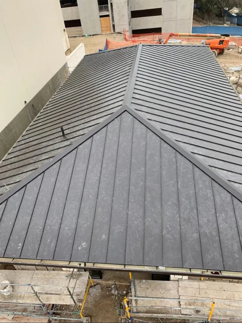 Commercial metal roof construction with crane equipment in Hawthorne