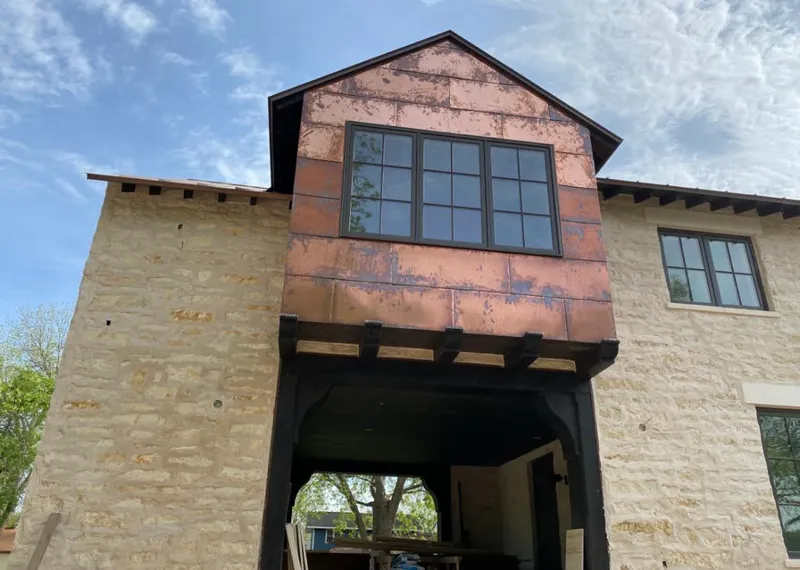 Copper metal panel facade on a stone building for Skylight Installation in Hawthorne